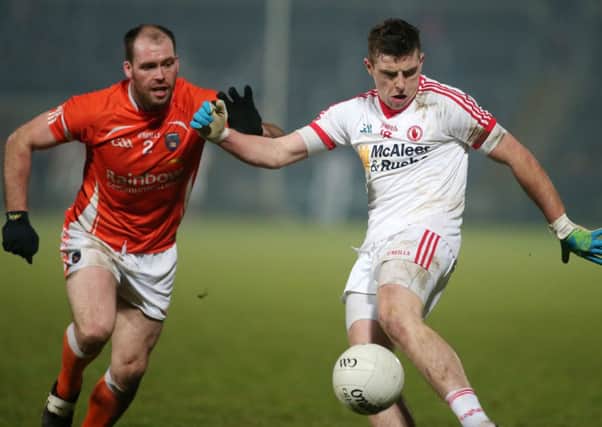 Armagh's  Mark McConville tackles Tyrone's Connor McAlliskey.
