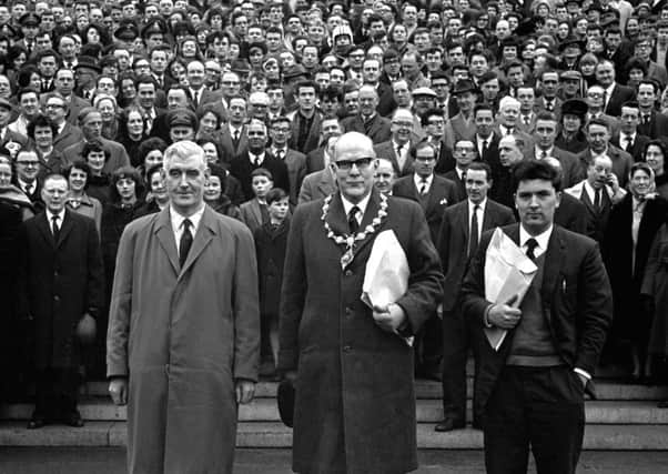 Some of the estimated 25,000 who took part in the University for Derry Campaign Motorcade from Londonderry pose on the steps of Parliament Buildings, Stormont, Belfast, on 18 February 1965. The campaign was lead by (from left) Eddie McAteer, Nationalist MP for Foyle, Albert Anderson, Mayor of Derry, and John Hume, campaign organiser. This last ditch effort to secure the new university for Derry failed as on March 4 1965 the Stormont Parliament voted in favour of the Lockwood Report's choice, Coleraine. 196502180001.Copyright Image from Larry Doherty, c/o Victor Patterson, 54 Dorchester Park, Belfast, UK, BT9 6RJ..Tel: +44 28 9066 1296.Mob: +44 7802 353836.Voicemail +44 20 8816 7153.Skype: victorpattersonbelfast.Email: victorpatterson@mac.com.Email: victorpatterson@ireland.com (back-up)..IMPORTANT: If you wish to use this image or any other of my images please go to www.victorpatterson.com and click on the Terms & Conditions. Then contact me by email or phone with the reference number(s) of the image(s) concer