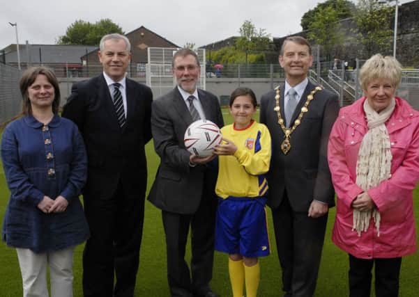 Social Development Minister Nelson McCausland MLA, pictured at the opening of the new multi use games area in the Fountain estate in 2012 with, from left, Cathy Arthur, Principal, Fountain Primary School, John Kelpie, Strategic Diretor, Derry City Council, Shantell Temple, captain of the Fountain Primary School girls football team, the Mayor, Alderman Maurice Devenney, and Jeanette Warke, club leader, Cathedral Youth Club. INLS2112-205KM