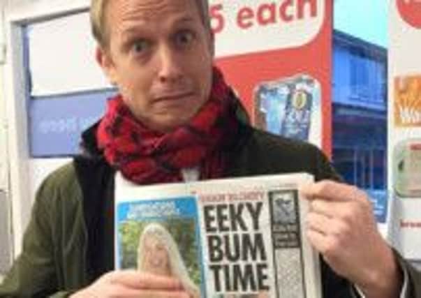 Rich Newell holds a copy of The Sun with his page 3 logo