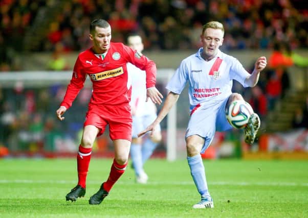 Cliftonville's Martin Donnelly and Ballymena's Stephen McBride in action during the Wasp Solutions Cup Final at Windsor Park in Belfast. 

Picture - Kevin Scott / Presseye