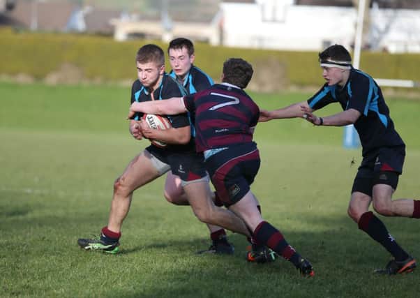 Carrick's Tom Gilpin is tackled by BRA's David McCullough.