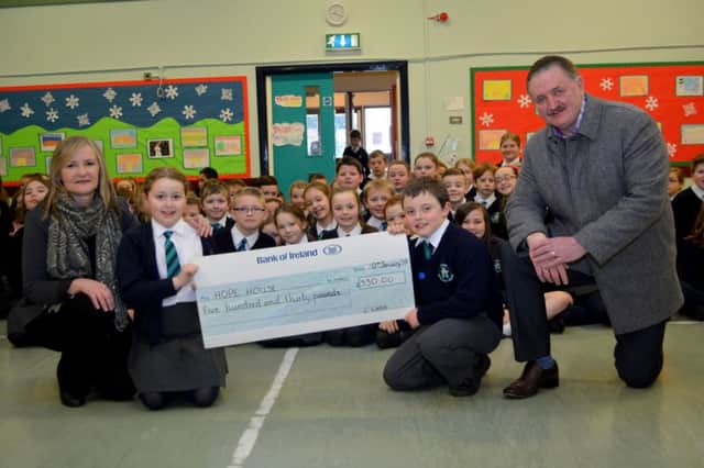 Abigail and McKenzie from Acorn Integrated Primary School present a cheque to Dawn McConnell and Brian Martin from Hope House in Whitehead. INCT 05-112-GR