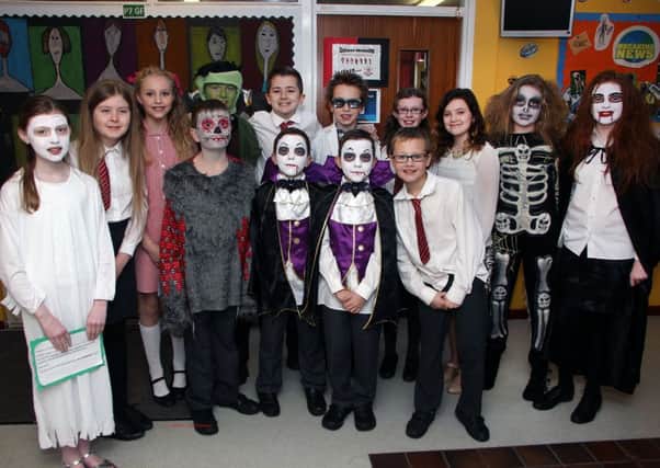Ready to tread the boards at Carniny Primary School last week were these pupils who took part in the school play "The Canterville Ghost". INBT 06-802H