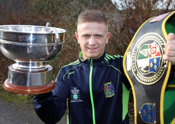Lisburn boxer Kurt Walker, who trains at Canal Boxing Academy, holds up the Irish Senior Championship cup and belt after winning them in Dublin at the national boxing championships. The awards are the highest it is possible to win in Irish boxing. US1504-551cd  Picture: Cliff Donaldson