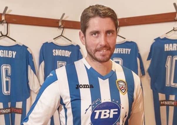 New Coleraine No.4 Ruaidhri Higgins checks out the "stripes" before his first training session at the club.
photo:Derek Simpson