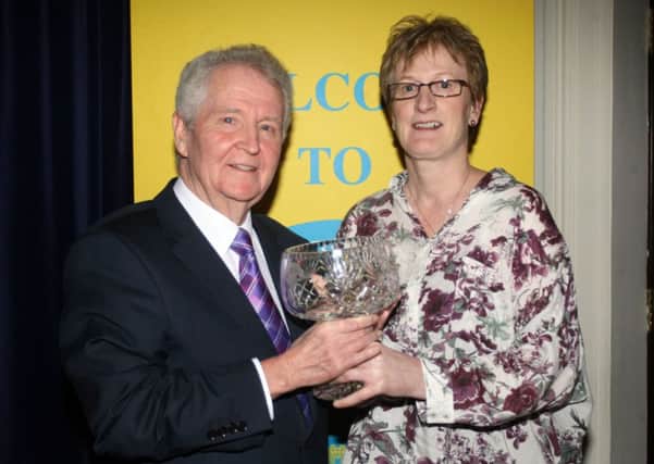 Barbara Cameron receives the Sporting Performance of the Year award from sponsor Don Stirling, of Stirling Trophies. INBT06-226AC