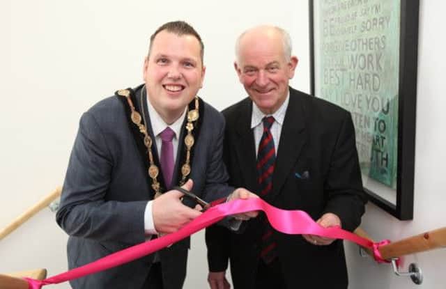 Mayor Andrew Ewing and Ian Murray, chairman of Home Start, cut a ribbon to open the organisation's new premises in Lisburn. US1504-549cd  Picture: Cliff Donaldson