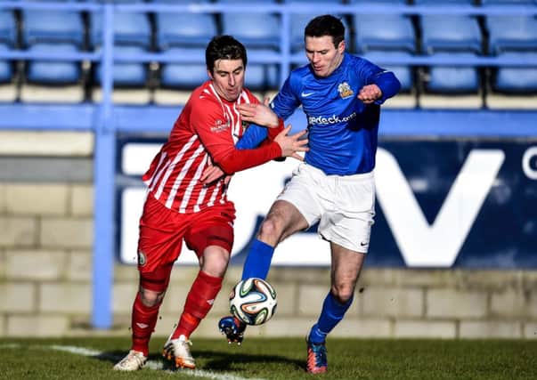 Glenavon's Kevin Braniff and Warrenpoin'ts John Boyle in action.