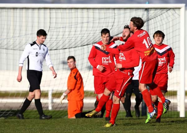 Ballyclare's Andrew Doyle celebrates scoring against Distillery during Saturday's Championship 1 game at Ballyskeagh. Photo: William Cherry / Presseye