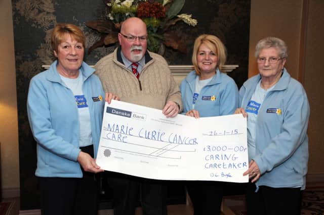 Davy Boyle (The Caring Caretaker) pictured presenting a £3000 cheque to Anne Connor, Donna Ferguson and Betty Linton representing the Marie Curie Cancer Care Coleraine fundraising group. INCR5-317PL