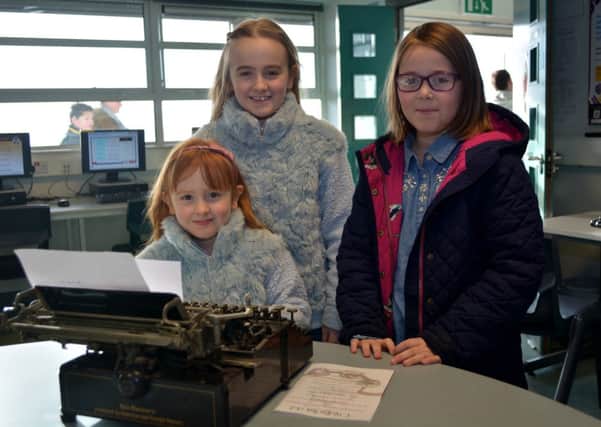 Darcey Matchett with Leah and Rowan Barnley play with a typewriter at the Ulidia Integrated College open day. INCT 06-179-GR