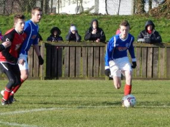 Matthew Holloway drives forward for Banbridge Rangers against the Town Juniors.