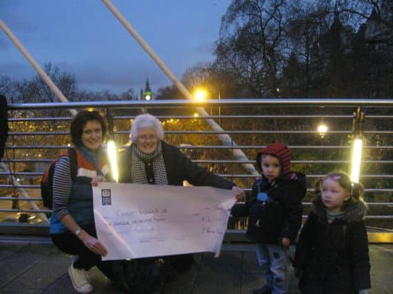 Pat and Adrienne, accompanied by Niamh and Karl, hand over the cheque. INBM06-15