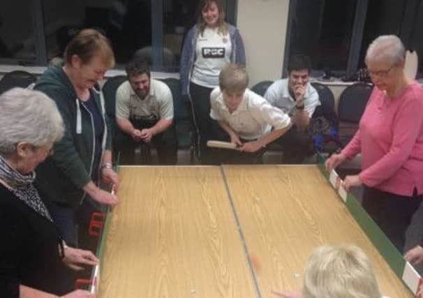Members of Templepatrick CC and Grange Womens Community Group play Table Cricket. INLT 06-907-CON