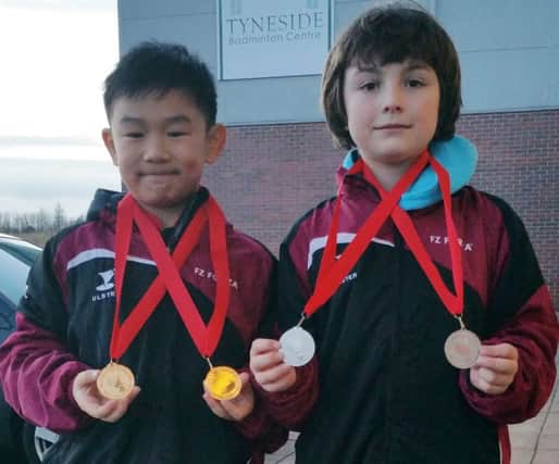 Laden down with their medals from the Under 11 Northumberland Badminton Tournament and the Under 13 Bronze Competition are Matthew Cheung and Stuart McCollam from Alpha.