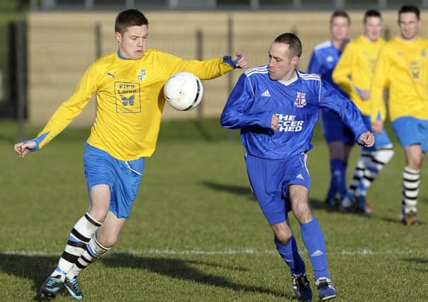 Rathfern's David Moore and Wellington Rec's Lloyd Baxter vie for possesion in Saturdays game at the Diamond. Photo: Philip McCloy
