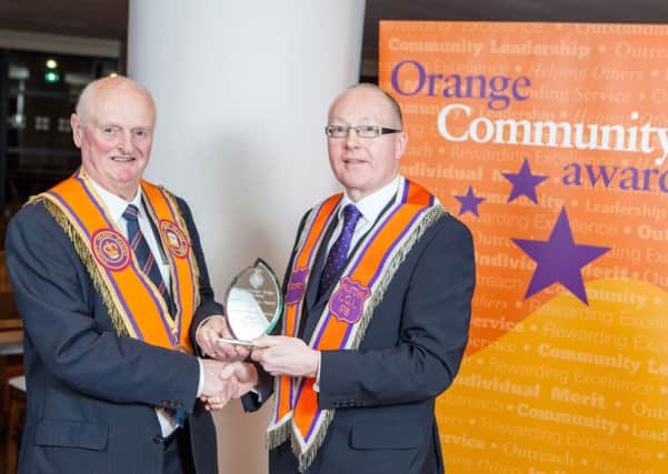 Alan Nicholl, LOL 176, (right) received the Outstanding Community Leadership Award for his pivotal role in the sourcing of a new Orange hall at Hillstown. The impressive hall is now a hub for the local community and through the newly formed community group, a number of new activities have been started. Bro Nicholl has been Worshipful Master of his lodge for five years. Also pictured presenting the trophy is award sponsor, Henry Latimer.(Submitted)