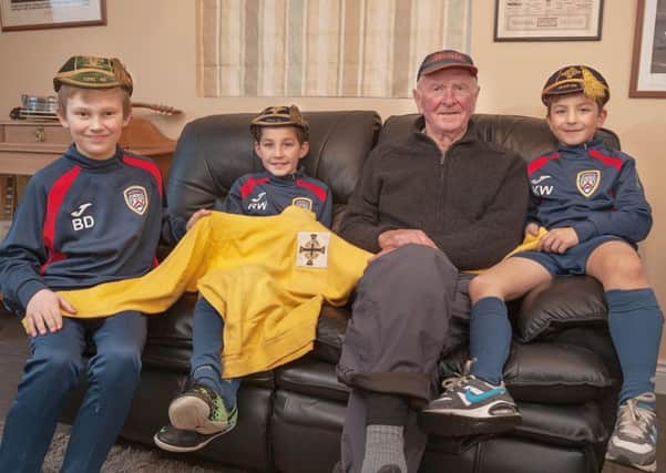 Coleraine Academy players Ben, Rhys and Kaleb get to meet the legend behind the Harry Gregg Foundation hear some of his stories and touch some mementos of his amazing career. Picture by Derek Simpson