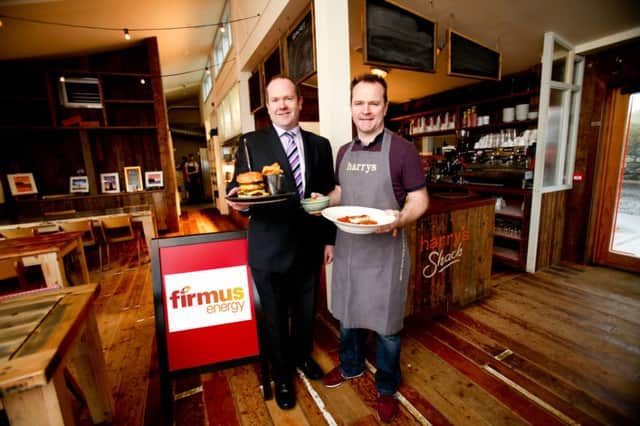 Kevin Flanagan (left) from firmus energy gets ready to sample some of the award-winning food from Harrys Shack with the restaurants owner and manager, Donal Doherty.