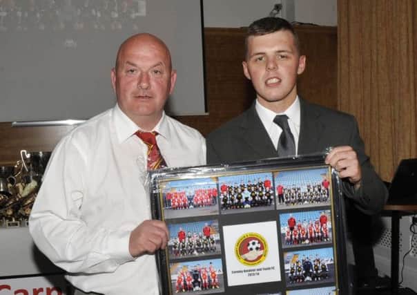 Carniny Youth Chairman Anthony McCartney presents a team photo montage to club kit sponsor Stuart Hunter of McDonald's Ballymena -