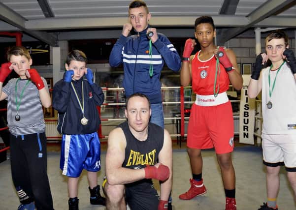 Lisburn Boxing Club's Ben Lancaster, Ryan Roy, Karim Finlay, Mosa Kambule, Declan Moore, and  Head Coach Martin Laverty with all the medals won at the County Antrim 3's in January at Avoneil Leisure Centre US0615-403PM Pic by Paul Murphy