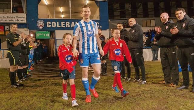 Faith, Johnny and Jack Watt are applauded on to the pitch at Johnny's testimonial match between Coleraine and Derry City. photo:Derek Simpson