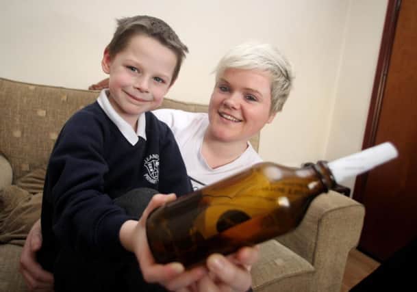 Schoolboy Noah White is pictured with his bottle and his aunt Stacey. INBM07-15 KMA