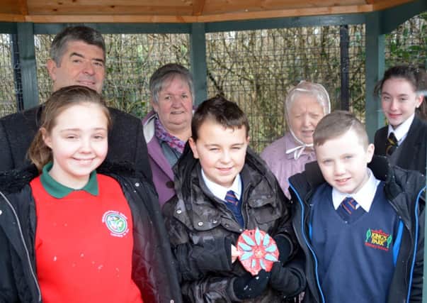 Cllr Billy Webb, Rosemary McFadden, Ann Robinson, Zeta West, Jo Balintine, Adam Ball and Cameron Sheilds with one of the many mosaic tiles which decorate the sensory garden at Inniscoole Day Centre. INNT 06-136-GR