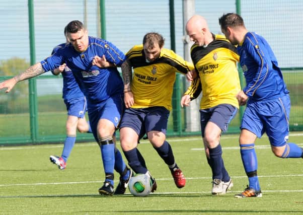 Cookstown RBL and Desertmartin Swifts battle for the ball in the middle of the park