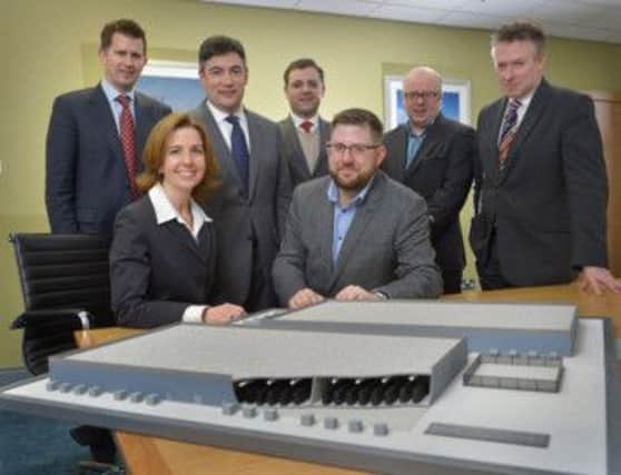 Carla Tully, President of AES UK & Ireland and guests with a model of the approved energy storage facility. INCT 06-796-CON
