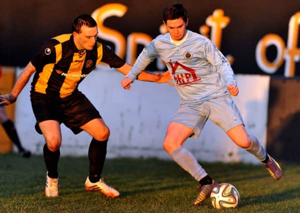 Carrick Rangers' Glen Taggart tussles with Institute's Michael McCrudden, during Saturday's Irish Cup tie, at Taylor's Avenue. Picture by Tony Hendron/Presseye