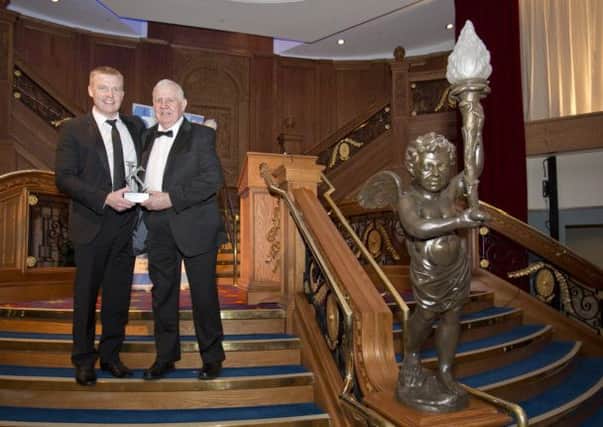 Glen Wright, David Wright, Directors, Wrights Design House, with their award on the iconic Titanic staircase