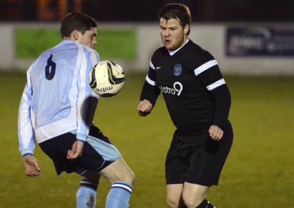 Claudy Rovers midfielder Connor McDermott (No 6) tries to win possession from Ardmore's Damien Campbell during Friday night's League Cup Final.