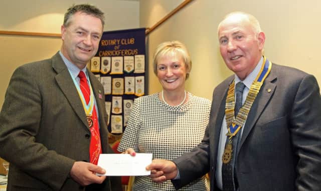 William Cross, Rotary assistant governor, accepts the cheque for the Northern Ireland Cancer Fund for Childrens Daisy Lodge project from Brenda Houston, Carrickfergus Rotary president elect and Sam Crowe, president. INCT 07-705-CON