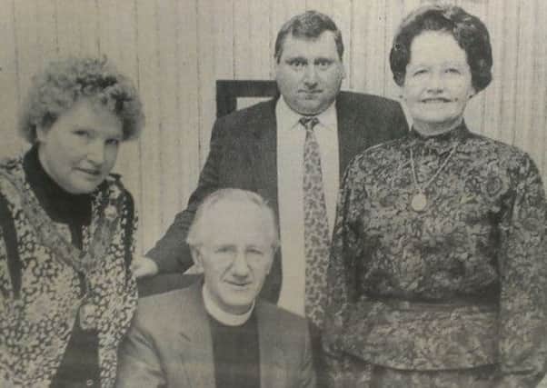 The Moderator of the Presbyterian Church in Ireland, The Very Rev Dr James Matthews, signing the visitors book when he was entertained to tea at Magherafelt Council in 1990 when he toured the area. Included are Mrs Matthews, Cllr Mary McSorley, Chairperson of the Council, and Vice-chairman Bertie Montgomery.