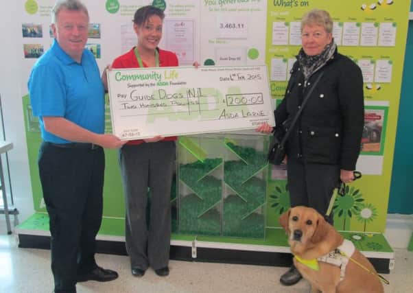 Jena Brodison, Asda Section Manager presenting a £200 cheque to John Hilditch from Guide Dogs NI. The organisation won the November/December Chosen By You, Given By Us green token scheme in ASDA Larne. INLT-07-715-con