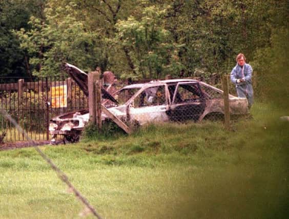 PACEMAKER BELFAST 25/9/02
Burnt out car at the scene where Sean Brown's body was found near Randelstown in Co. Antrim