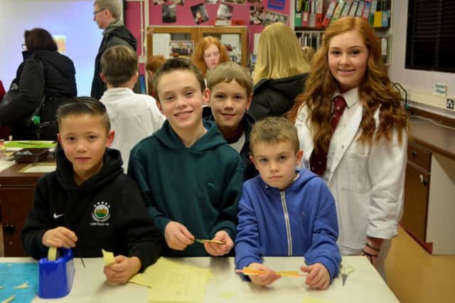 Mark Norris, Robbie Taylor and Josh and Andrew Kale making rockets with help from Natasha Simpson at Carrickfergus Grammar School open night. INCT 06-151-GR