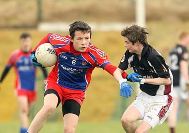 Aaaron Doherty Colaiste na Carraige finds his way blocked against against St.Joseph's Coalisland in Irvinestown on Friday. Photo Thomas Gallagher INDP1602 Colaiste na Carraige TG5