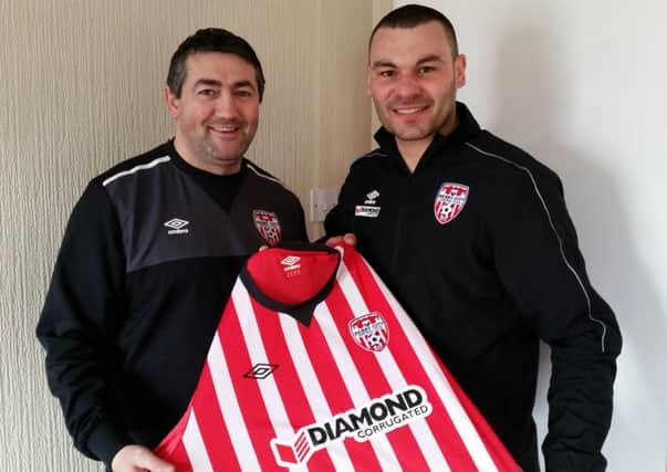 Derry City manager Peter Hutton welcomes new signing Anthony Elding.