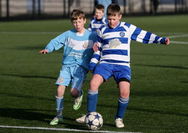 Northend's Caolin Lennon keeps the ball from Ballymena Youth's Lewis Tennant. INBT08-259AC
