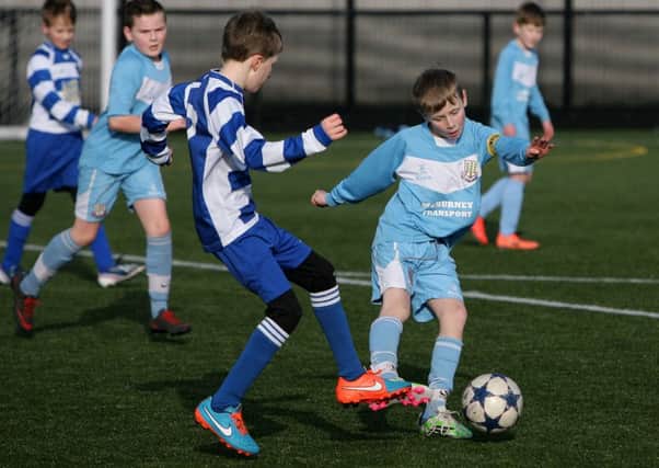 Ballymena United Youth player Lewis Tennant comes under pressure from his Northend Under 11 opponent. INBT08-261AC