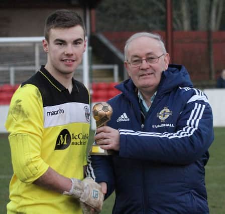 Lisburn Distillery goal-keeper Ryan McBride was presented with the Man of the Match award by IFA Intermediate Cup committee member Bob Fenton after Saturday's win over Ballyclare Comrades. The young keeper capped off a fine afternoon with two saves in the penalty shoot-out. Picture - David Hunter.
