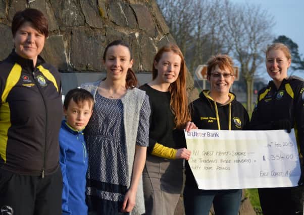 East Coast AC committee members Marie Glover (left) and Catherine Maxwell had the honour of presenting a cheque for £1,354 to Patricia, Trisha, Bernadette and Christopher Campbell.