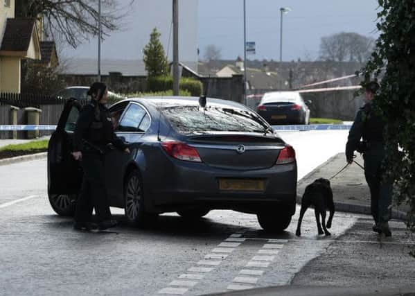SECURITY ALERT. . . .A police dog is brought in during yesterday's security alert at Broomhall Avenue, Nelson Drive, Waterside, Derry. DER0715MC062
