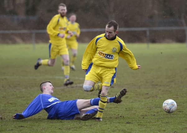 Churchill United's Barry Gillespie hurdles this tackle from a Roe Rovers Reserves defender. INLS0815-131KM