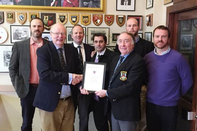 Ballymena Rugby Club President, Mr. Guy McCullough, hands over a certificate of Honorary Membership of Ballymena Rugby Football Club to Mr. Harry Fisher, marking his dedicated support to the Eaton Park club over many years.  Included in the photograph are members of Mr Fishers family.