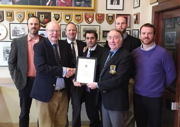 Ballymena Rugby Club President, Mr. Guy McCullough, hands over a certificate of Honorary Membership of Ballymena Rugby Football Club to Mr. Harry Fisher, marking his dedicated support to the Eaton Park club over many years.  Included in the photograph are members of Mr Fishers family.