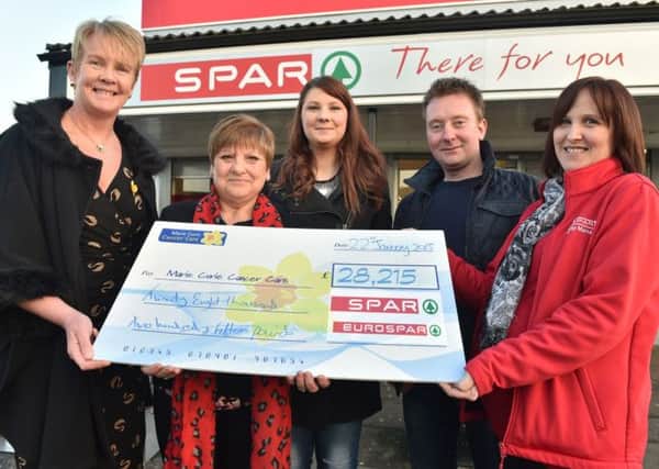 L-R:  Partnerships Manager at Marie Curie Anne Hannon receives the cheque from Natalies mother Irene Cooke, daughter Kirsty Fyffe, partner Ivan Shanley and Spar King's Crescent Store Manager Arlene Simmons. INNT-08-700-con